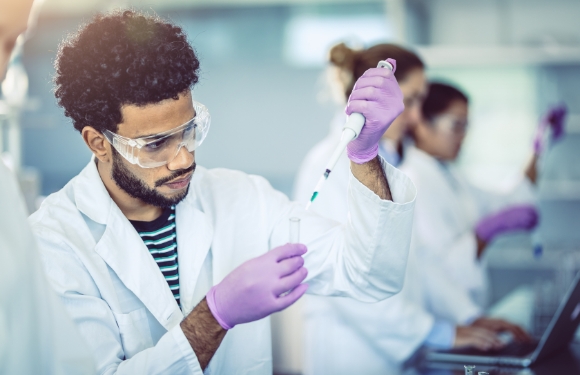 Man with pipette in a lab