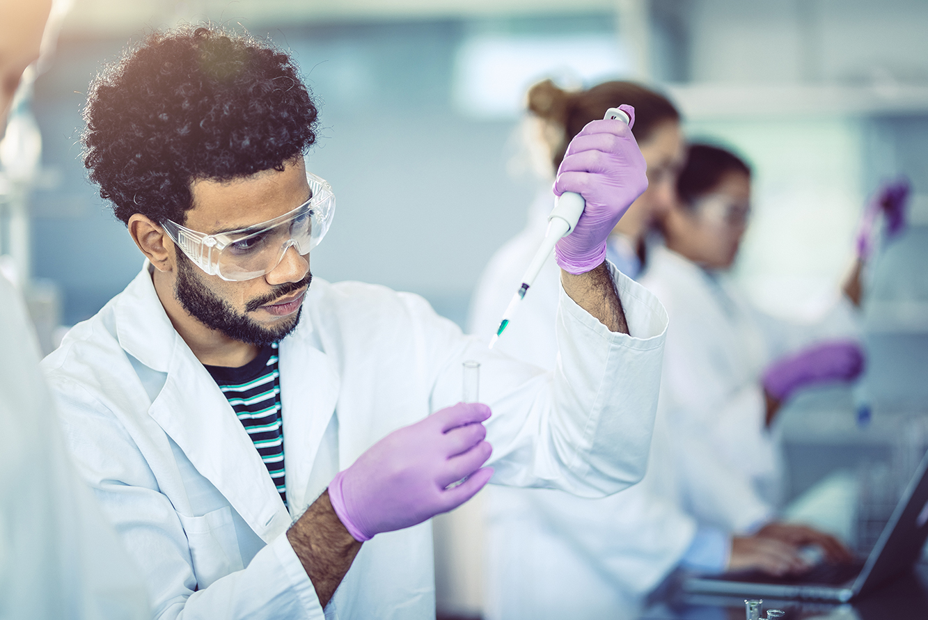 Man with pipette in lab